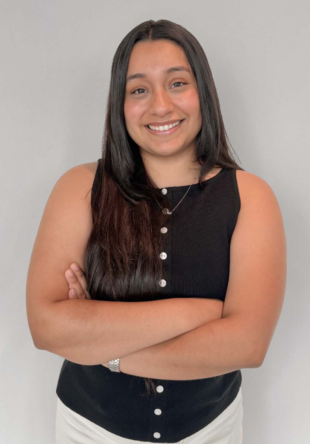 Zitlali, Lead Treatment Coordinator at Braces Now, smiling and crossed arms.