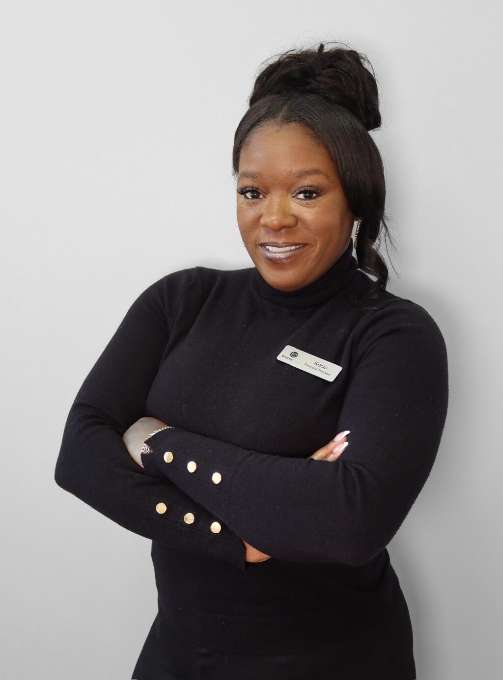 Kecia, Braces Now Financial Manager, smiling and confidently posing for a team portrait.