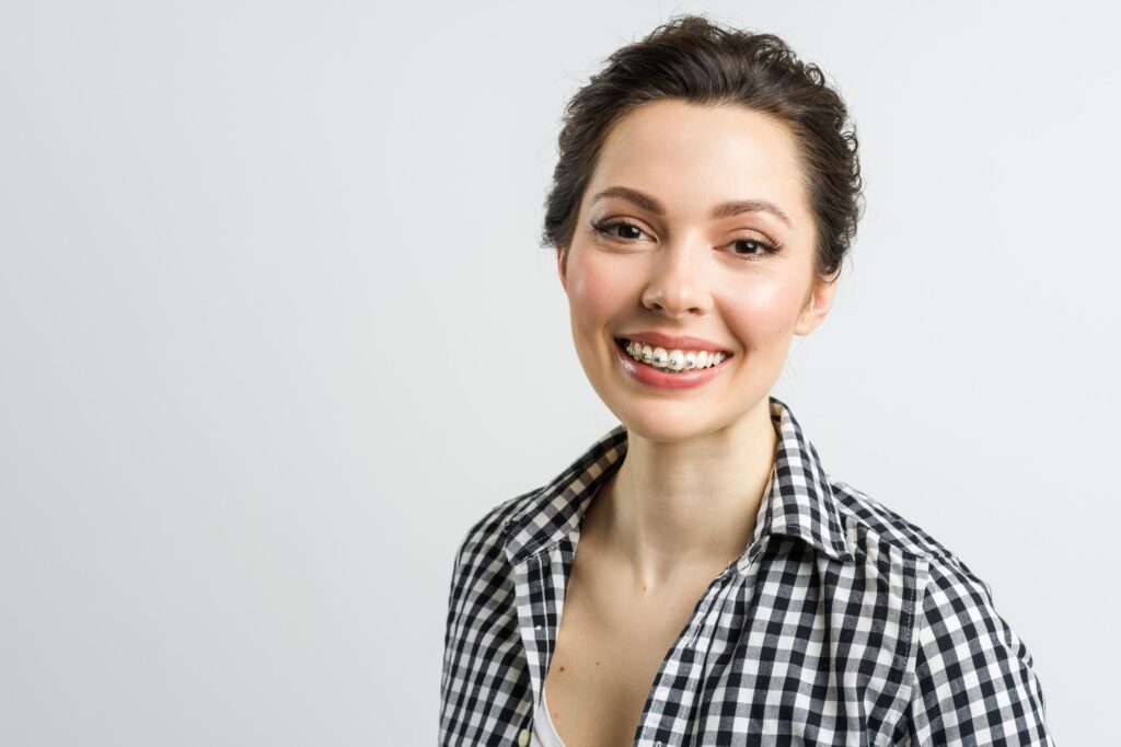 Adult woman smiling with metal braces